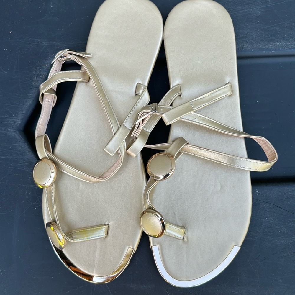 Gold flat sandals with adjustable straps